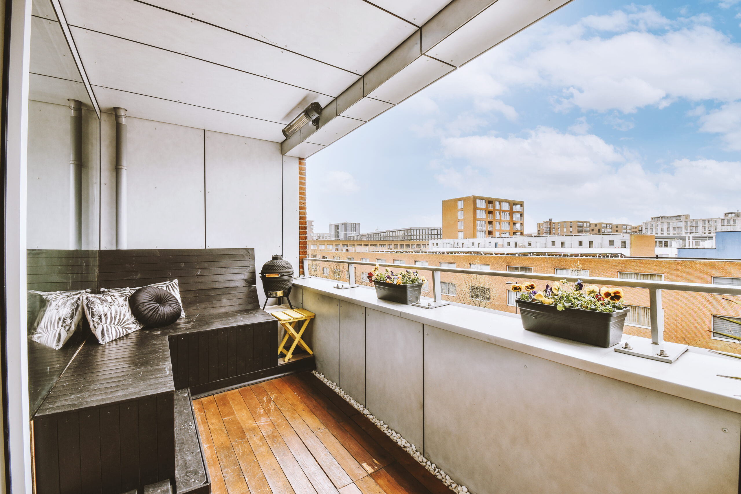 corner wooden furniture on the open balcony of an apartment building