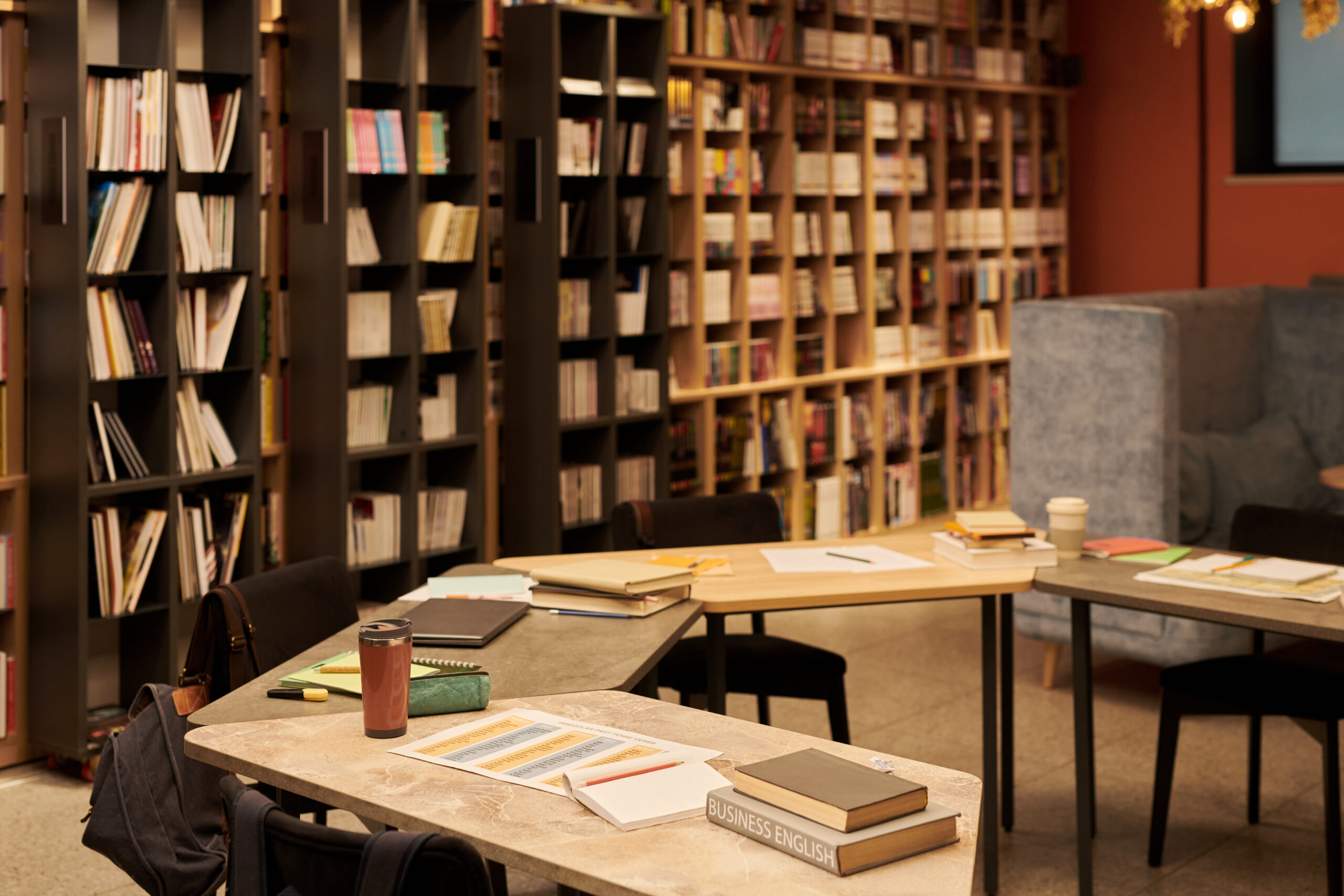 empty library tables with books and notebooks awaiting students