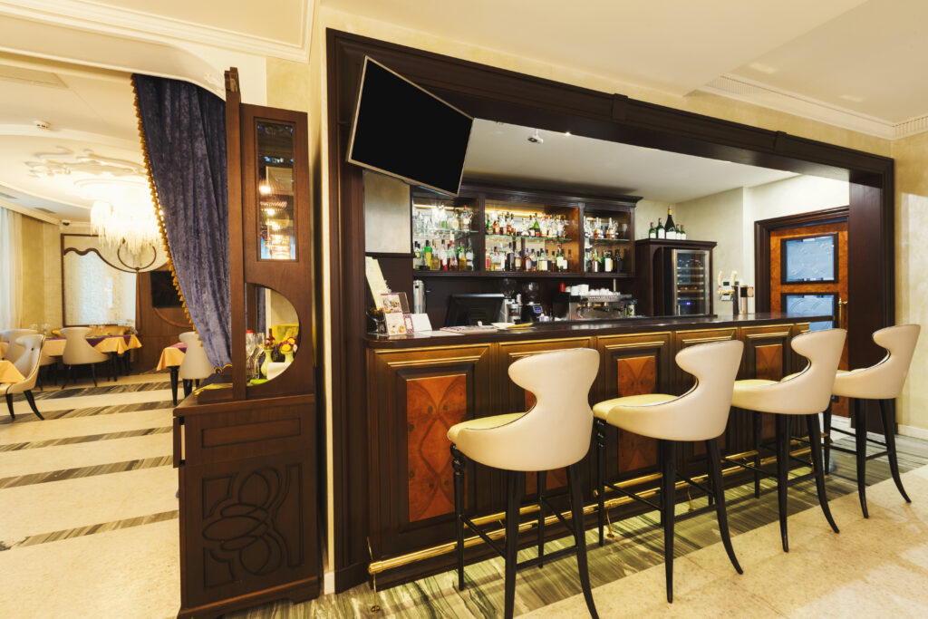 hotel lounge bar with bottle shelfs and seats